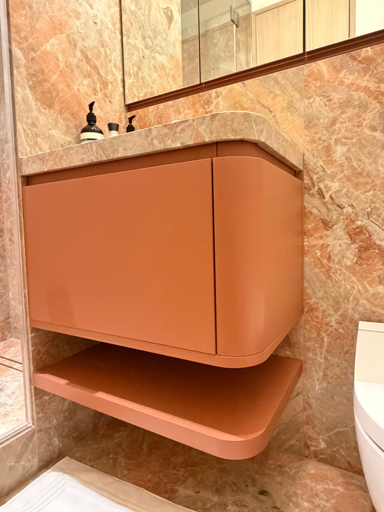 Curved terracotta wall-mounted bathroom vanity