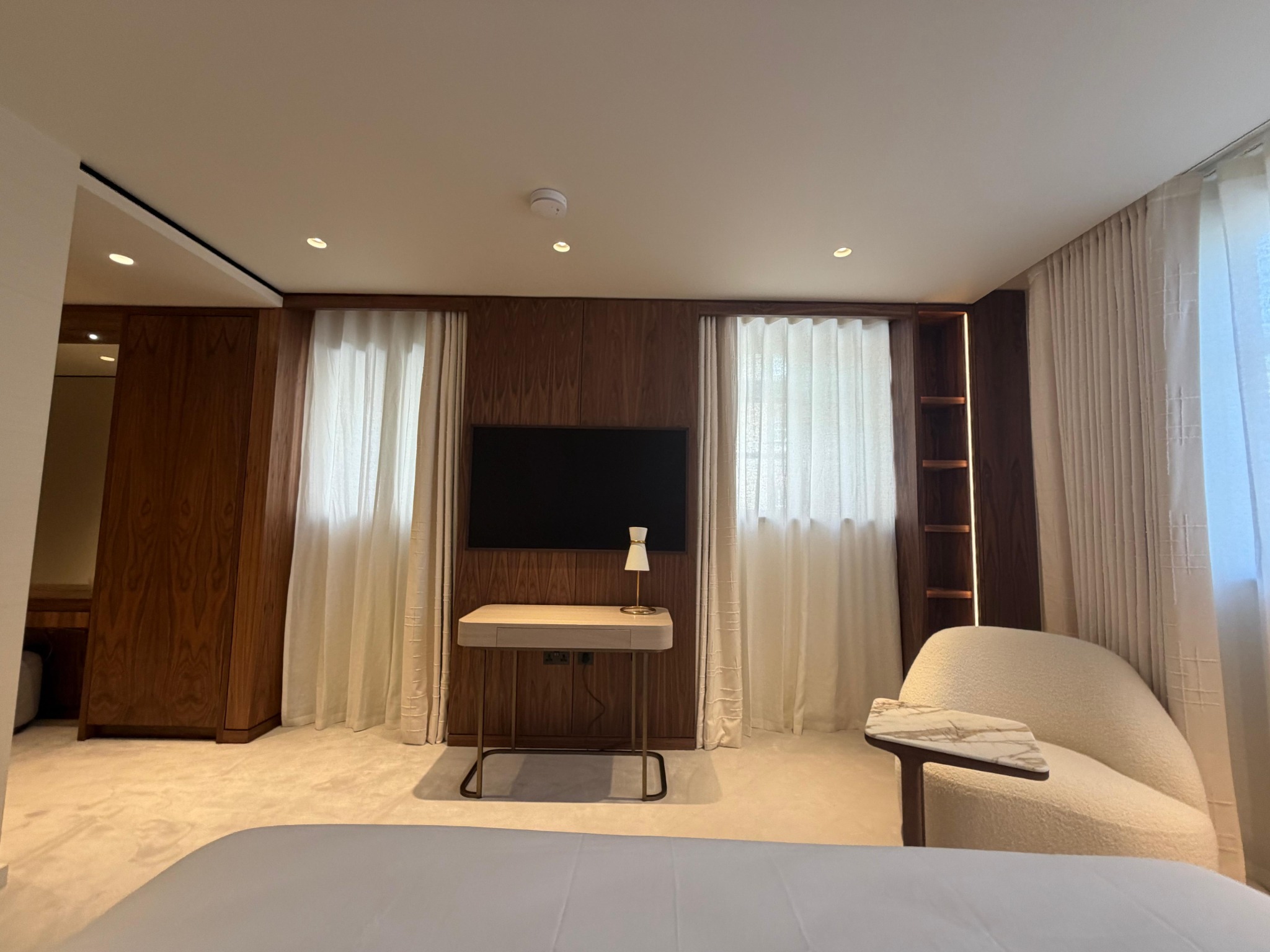 Bedroom with timber wall panelling and a fitted dressing table