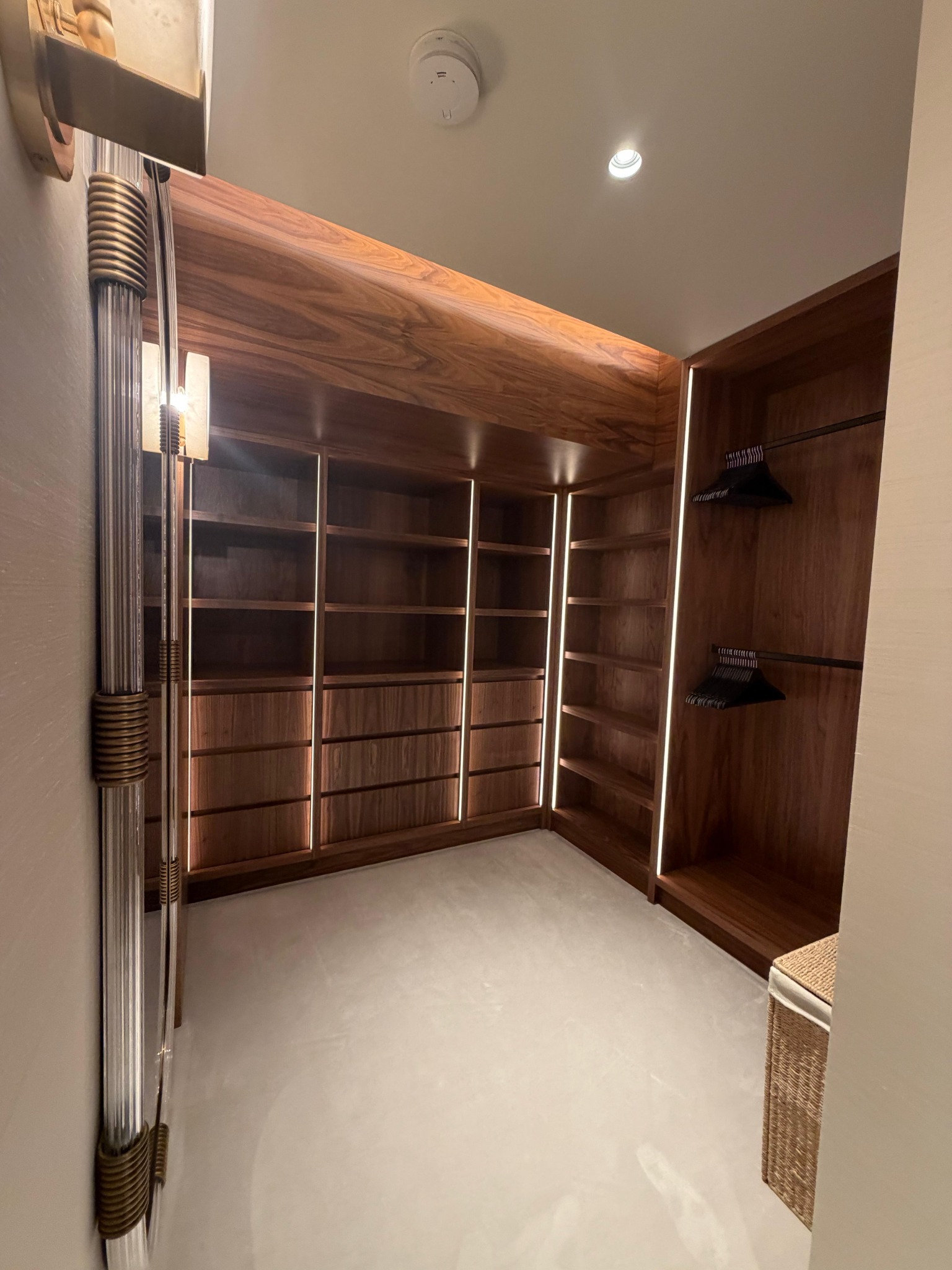 Timber dressing room with illuminated shelving and fitted storage