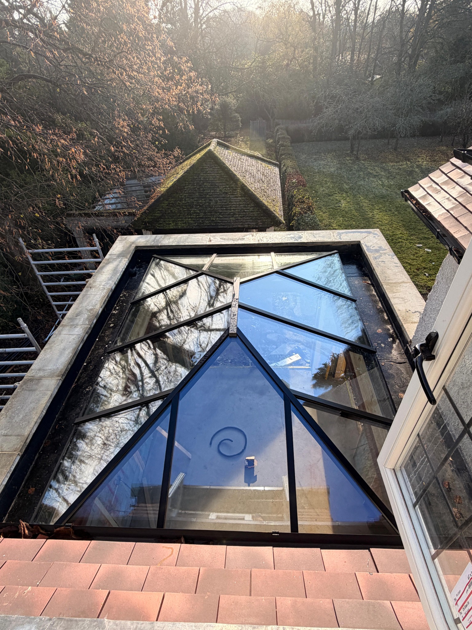 Black-framed glazed roof lantern viewed from above